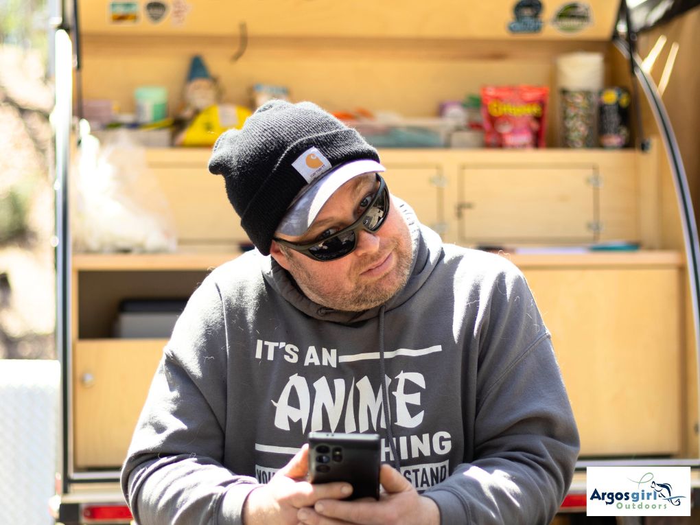 man wearing a grey sweatshirt looking at the camera