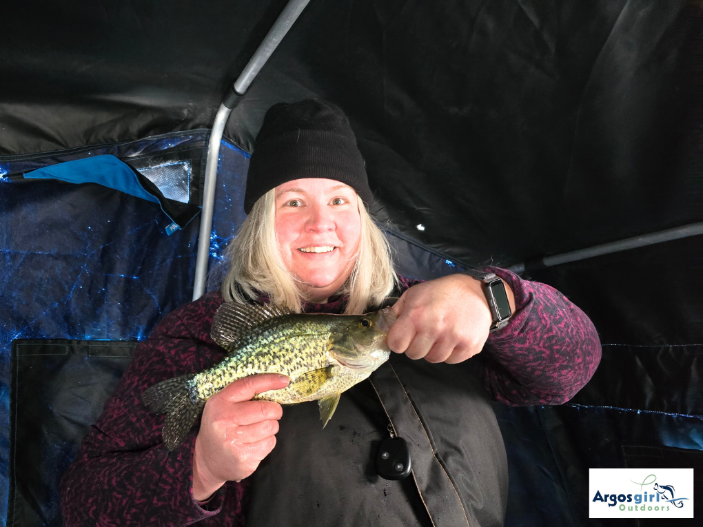 woman holding a black crappie caught at island lake
